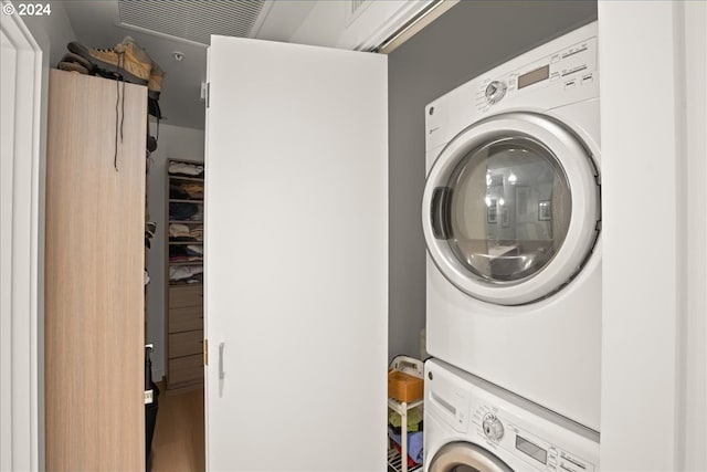 laundry room featuring stacked washer / drying machine