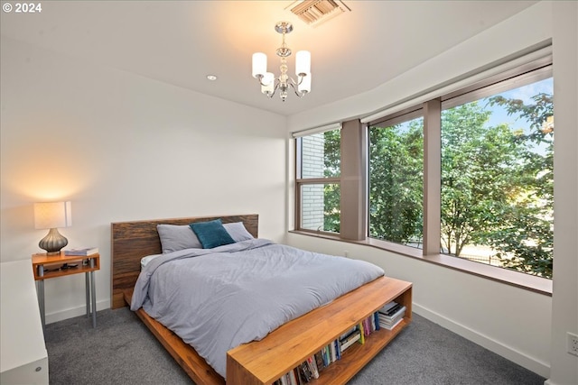 carpeted bedroom featuring an inviting chandelier