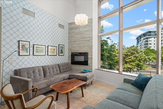 living room featuring light hardwood / wood-style floors and a tile fireplace