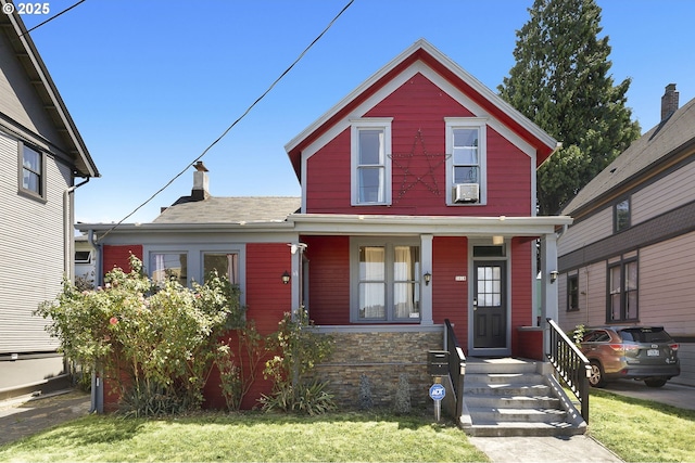 view of front of property featuring cooling unit and covered porch