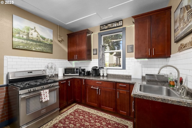 kitchen with stainless steel appliances, sink, and backsplash