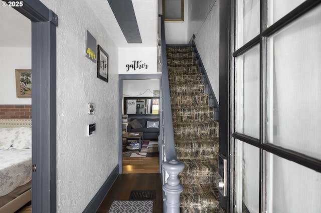 staircase with a healthy amount of sunlight and hardwood / wood-style floors