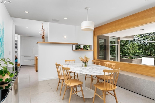 dining area with beam ceiling