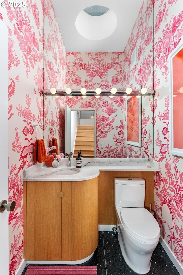 bathroom featuring toilet and vanity