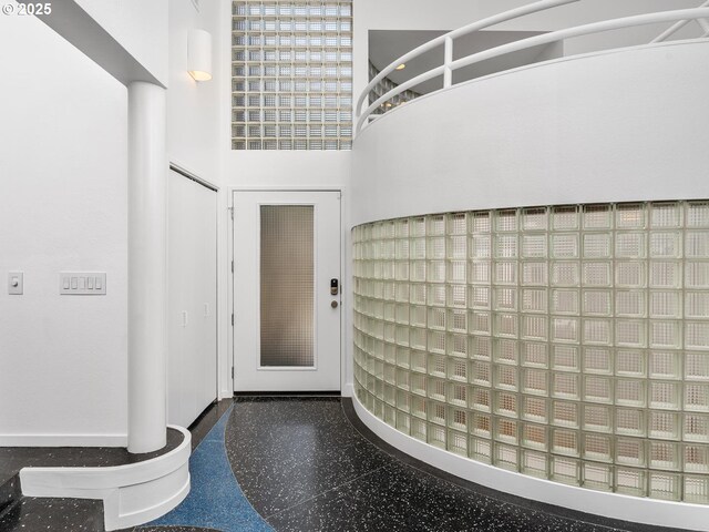 foyer featuring a towering ceiling