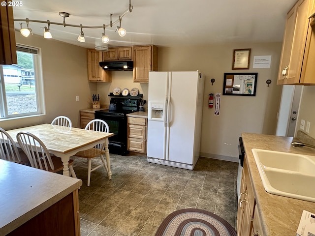 26230 Sandlake Rd, Cloverdale, OR 97112 - kitchen with white refrigerator with ice dispenser, black range with electric cooktop, under cabinet range hood, a sink, and light countertops