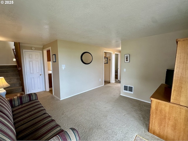 26230 Sandlake Rd, Cloverdale, OR 97112 - unfurnished living room featuring carpet floors, stairs, a textured ceiling, and baseboards