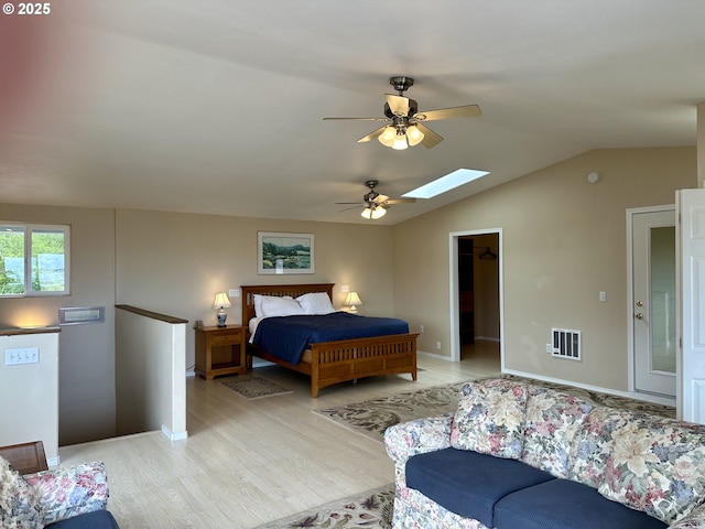 26230 Sandlake Rd, Cloverdale, OR 97112 - bedroom with light wood finished floors, lofted ceiling, a skylight, a walk in closet, and ceiling fan
