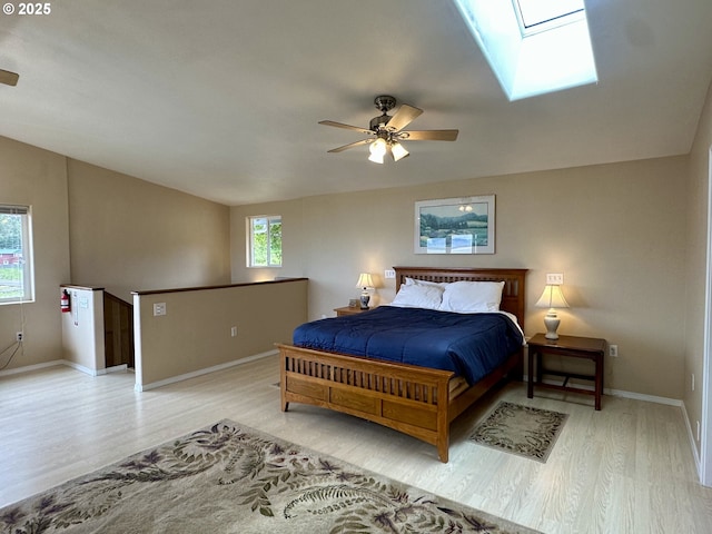 26230 Sandlake Rd, Cloverdale, OR 97112 - bedroom featuring wood finished floors, baseboards, a skylight, vaulted ceiling, and ceiling fan