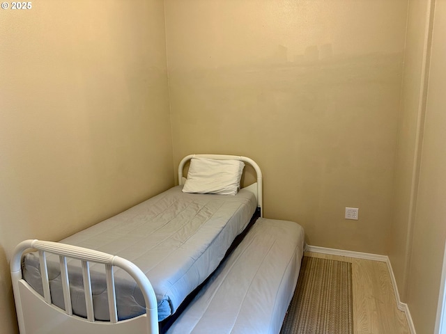 26230 Sandlake Rd, Cloverdale, OR 97112 - bedroom with baseboards and wood finished floors