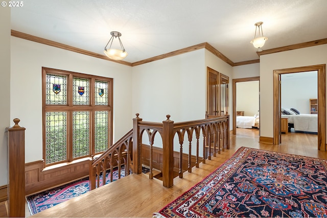 6633 SE 29th Ave, Portland, OR 97202 - hall featuring wainscoting, crown molding, an upstairs landing, and light wood finished floors