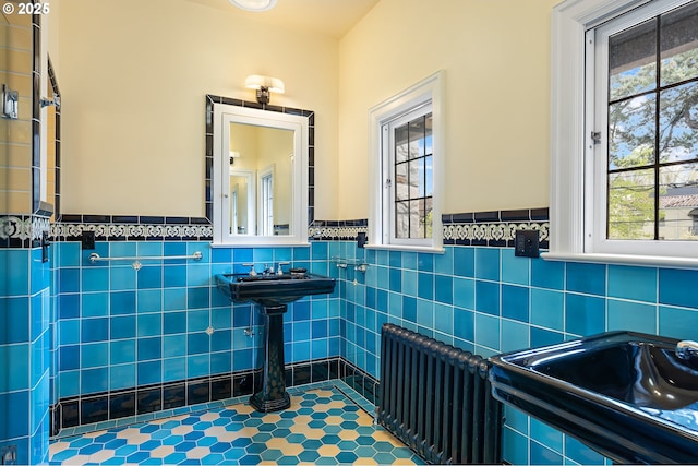 6633 SE 29th Ave, Portland, OR 97202 - bathroom featuring tile walls, radiator heating unit, wainscoting, and tile patterned flooring
