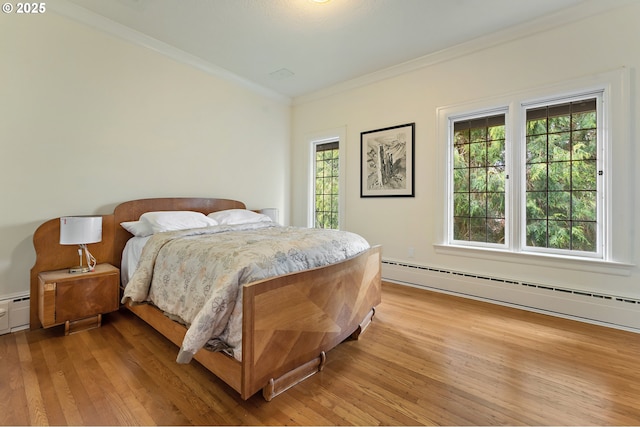 6633 SE 29th Ave, Portland, OR 97202 - bedroom with a baseboard heating unit, light wood-type flooring, and crown molding