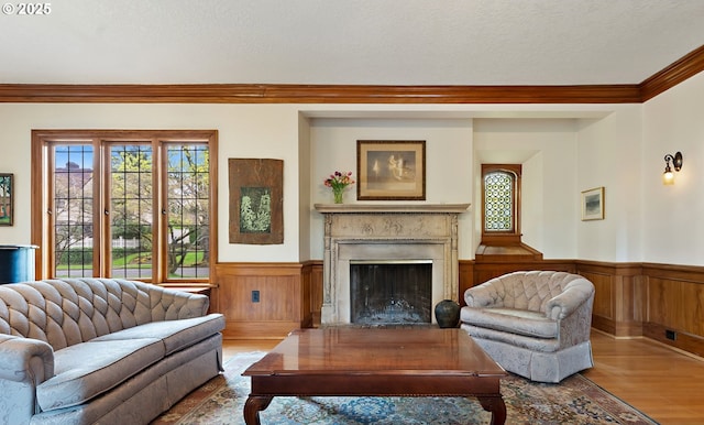 6633 SE 29th Ave, Portland, OR 97202 - living area with wainscoting, ornamental molding, wood finished floors, and a premium fireplace