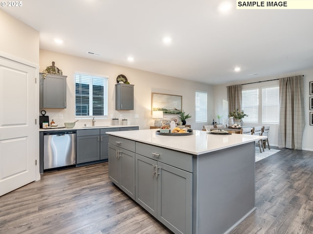 kitchen featuring dark hardwood / wood-style flooring, decorative backsplash, stainless steel appliances, and a center island