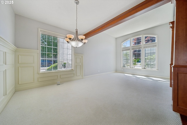 13733 NW Trevino St, Portland, OR 97229 - unfurnished dining area with a chandelier, plenty of natural light, carpet flooring, beam ceiling, and a decorative wall