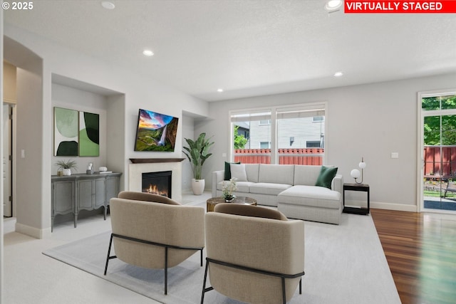 13733 NW Trevino St, Portland, OR 97229 - living area with a glass covered fireplace, recessed lighting, baseboards, and wood finished floors
