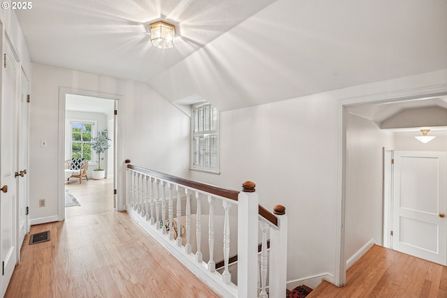 4317 SW Bernard Dr, Portland, OR 97239 - corridor featuring an upstairs landing, wood finished floors, baseboards, and vaulted ceiling