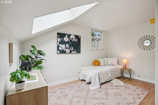 4317 SW Bernard Dr, Portland, OR 97239 - bedroom featuring a skylight, light wood-style flooring, vaulted ceiling, and baseboards