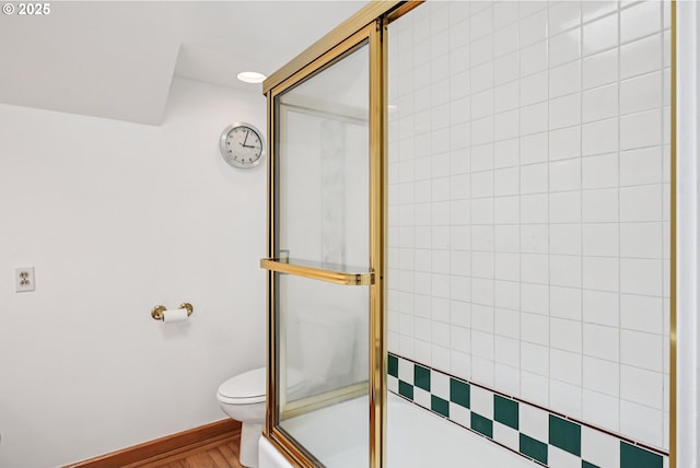 4317 SW Bernard Dr, Portland, OR 97239 - full bathroom with an enclosed shower, toilet, wood finished floors, and baseboards