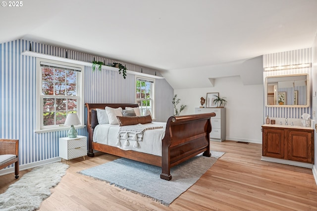 4317 SW Bernard Dr, Portland, OR 97239 - bedroom featuring lofted ceiling, light wood finished floors, and baseboards