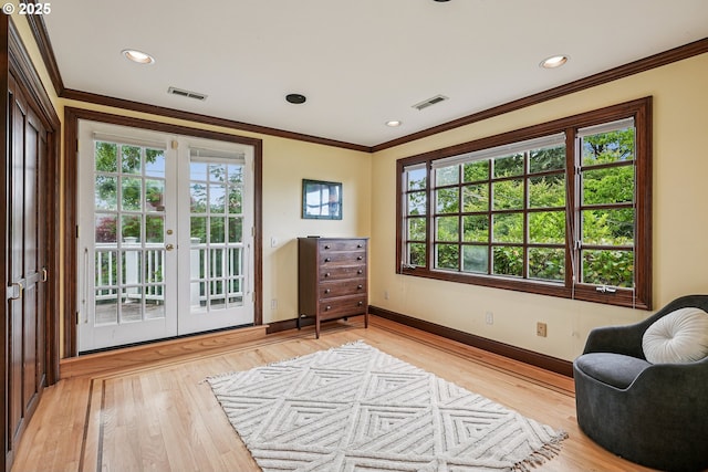 4317 SW Bernard Dr, Portland, OR 97239 - sitting room with crown molding, french doors, baseboards, light wood-style flooring, and recessed lighting