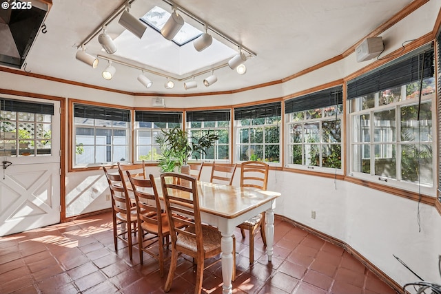 4317 SW Bernard Dr, Portland, OR 97239 - sunroom with track lighting, tile patterned floors, and crown molding