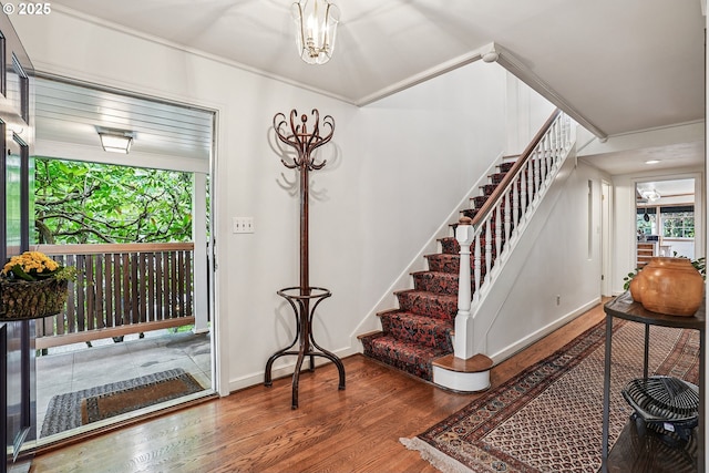 4317 SW Bernard Dr, Portland, OR 97239 - foyer entrance featuring wood finished floors, stairway, healthy amount of natural light, crown molding, and baseboards