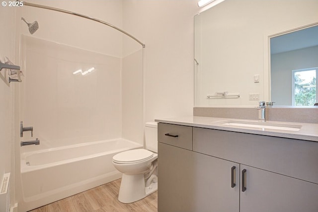 full bathroom featuring toilet, vanity, tub / shower combination, and hardwood / wood-style flooring