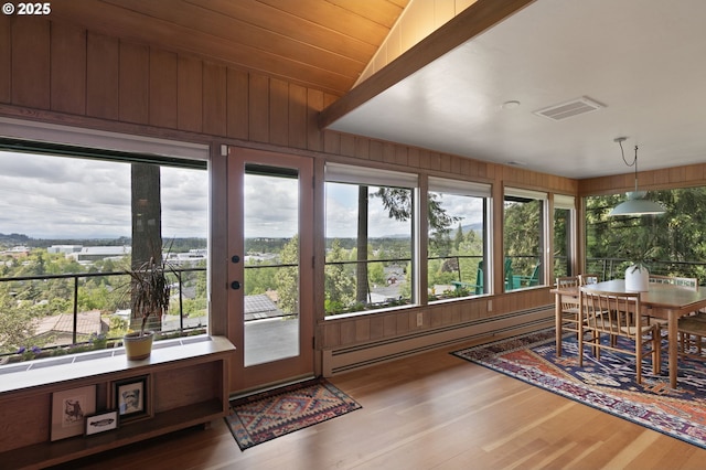 275 Sunset Dr, Eugene, OR 97403 - sunroom with a baseboard heating unit, wood finished floors, lofted ceiling, and wooden walls