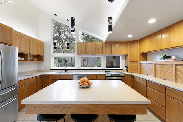 275 Sunset Dr, Eugene, OR 97403 - kitchen featuring stainless steel appliances, a kitchen breakfast bar, light countertops, brown cabinets, and lofted ceiling