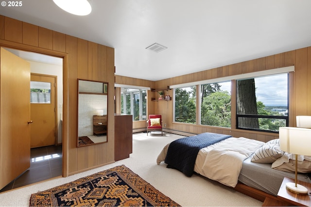 275 Sunset Dr, Eugene, OR 97403 - bedroom featuring multiple windows, wood walls, baseboard heating, and carpet floors