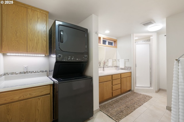 275 Sunset Dr, Eugene, OR 97403 - laundry area featuring stacked washing machine and dryer and light tile patterned floors