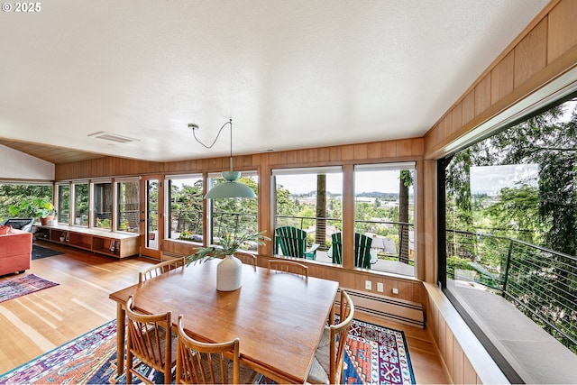 275 Sunset Dr, Eugene, OR 97403 - sunroom featuring a baseboard heating unit, wood finished floors, and a textured ceiling
