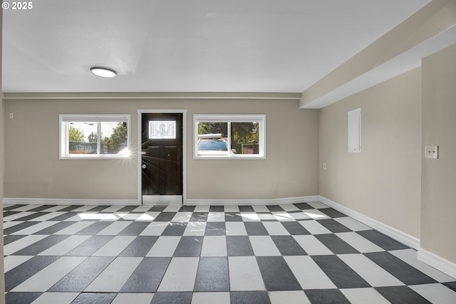 foyer with baseboards and tile patterned floors