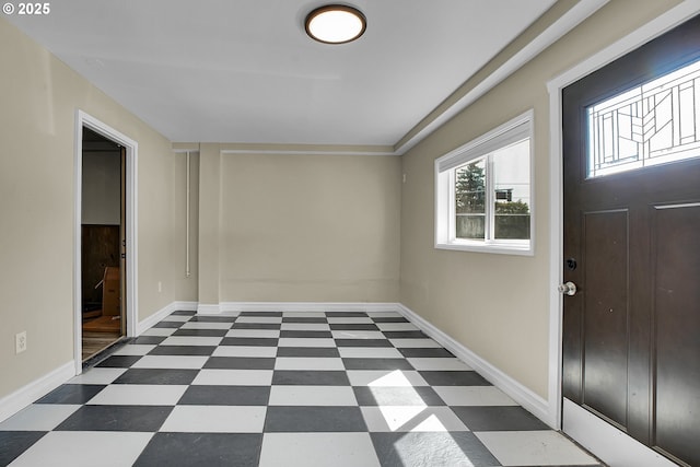 entryway featuring dark floors and baseboards