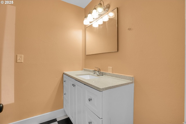 bathroom with vanity, baseboards, and tile patterned floors