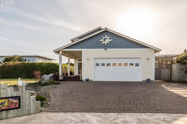 757 Newport Ave SW, Bandon, OR 97411 - view of front of property with a gate, decorative driveway, and an attached garage