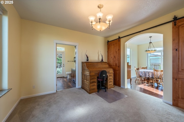 757 Newport Ave SW, Bandon, OR 97411 - carpeted home office with baseboards, a barn door, arched walkways, and an inviting chandelier
