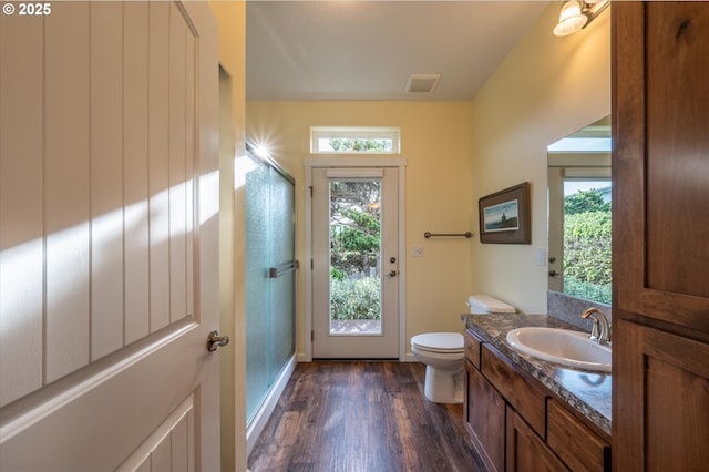 757 Newport Ave SW, Bandon, OR 97411 - bathroom featuring visible vents, a stall shower, vanity, and wood finished floors