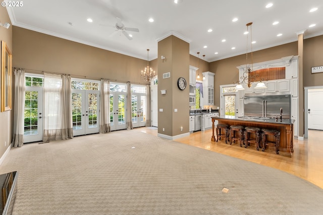 245 Winchester Creek Ave, Winchester, OR 97495 - living room featuring a ceiling fan, a towering ceiling, healthy amount of natural light, ornamental molding, and recessed lighting