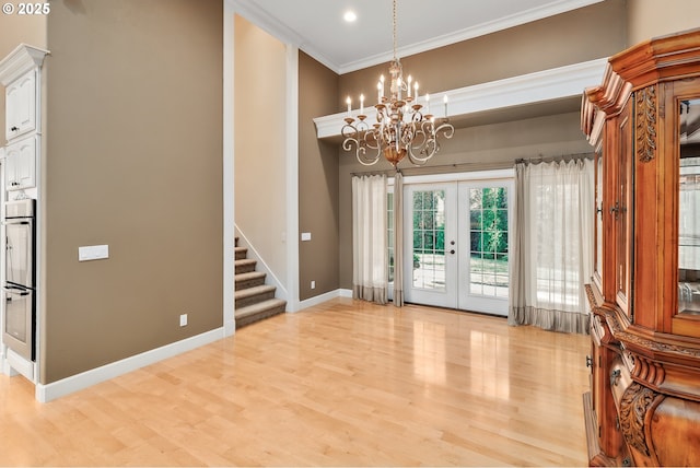 245 Winchester Creek Ave, Winchester, OR 97495 - foyer featuring french doors, stairway, a chandelier, light wood-style flooring, and ornamental molding