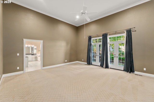 245 Winchester Creek Ave, Winchester, OR 97495 - spare room featuring a high ceiling, light colored carpet, a ceiling fan, french doors, and ornamental molding