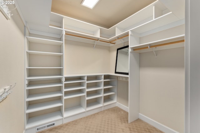 spacious closet with light carpet and visible vents