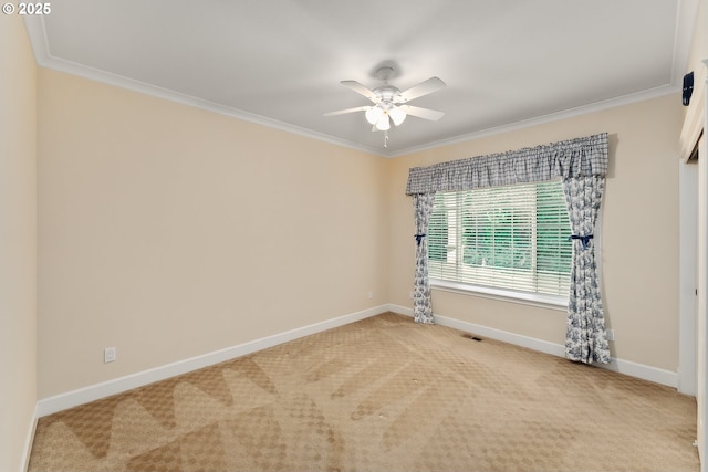 empty room with baseboards, crown molding, and light colored carpet