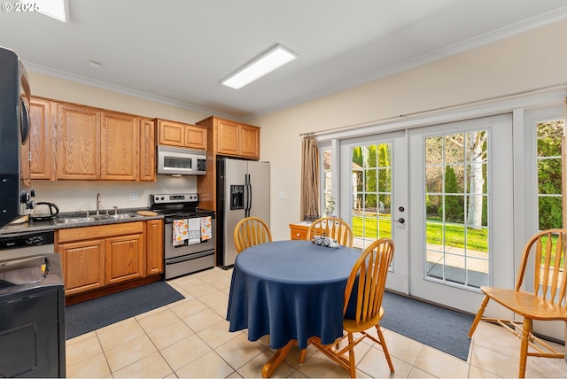 245 Winchester Creek Ave, Winchester, OR 97495 - kitchen with stainless steel appliances, dark countertops, plenty of natural light, ornamental molding, and light tile patterned flooring