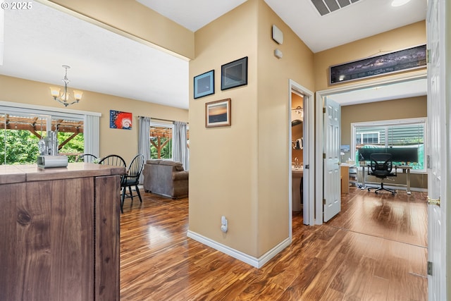 2855 NW Orchard Heights Ave, Albany, OR 97321 - hallway featuring an office area, wood finished floors, a chandelier, and baseboards