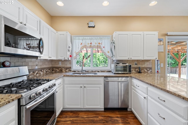 2855 NW Orchard Heights Ave, Albany, OR 97321 - kitchen featuring stainless steel appliances, a sink, healthy amount of natural light, recessed lighting, and white cabinets