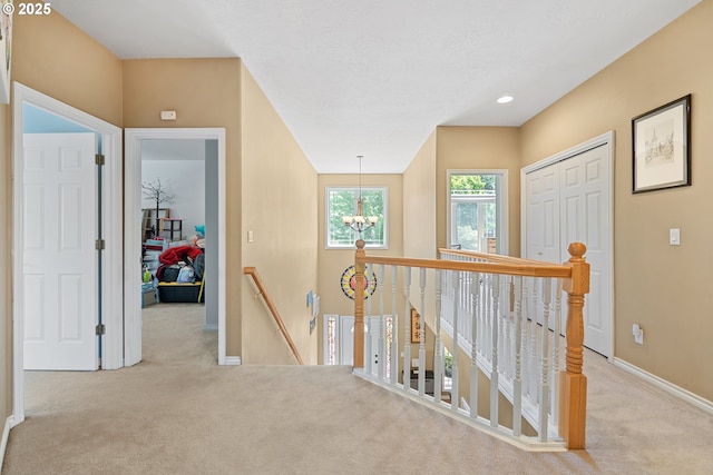 2855 NW Orchard Heights Ave, Albany, OR 97321 - hallway with an upstairs landing, carpet, baseboards, a chandelier, and recessed lighting