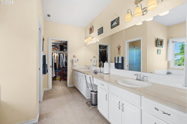 2855 NW Orchard Heights Ave, Albany, OR 97321 - bathroom featuring double vanity, a walk in closet, and baseboards